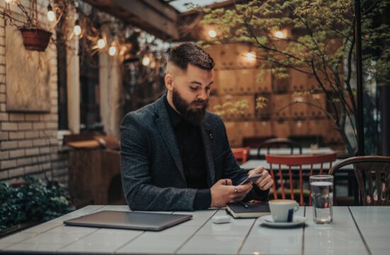 Businessman using smartphone in a cafe