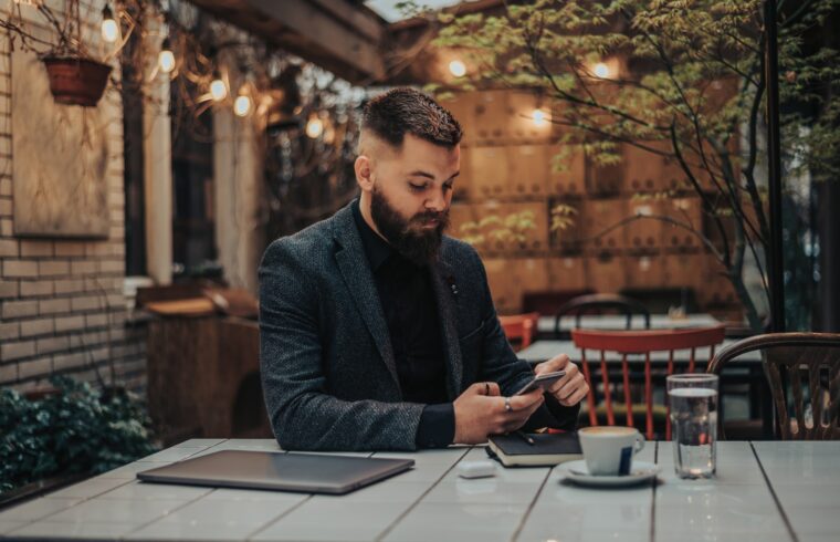 Businessman using smartphone in a cafe